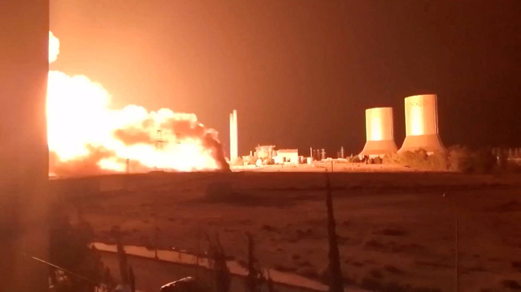 Flames rise at Tishreen thermal power plant following an explosion, near Otaybah